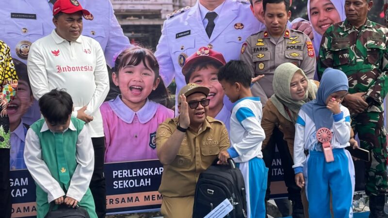 Bupati Kutai Kartanegara Aulia Rahman Basri menyerahkan seragam sekolah gratis bagi siswa di Tenggarong (Latif/Eksposisi)